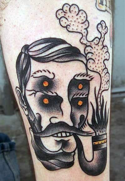 Tattoo of a stylized man's face smoking a pipe with decorative elements and orange accents
