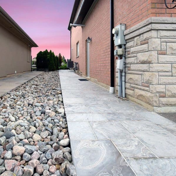 concrete steps with landscaping pebbles 