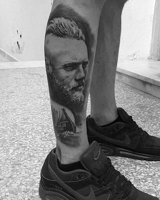 Tattoo of a Ragnar and a ship on a person's calf