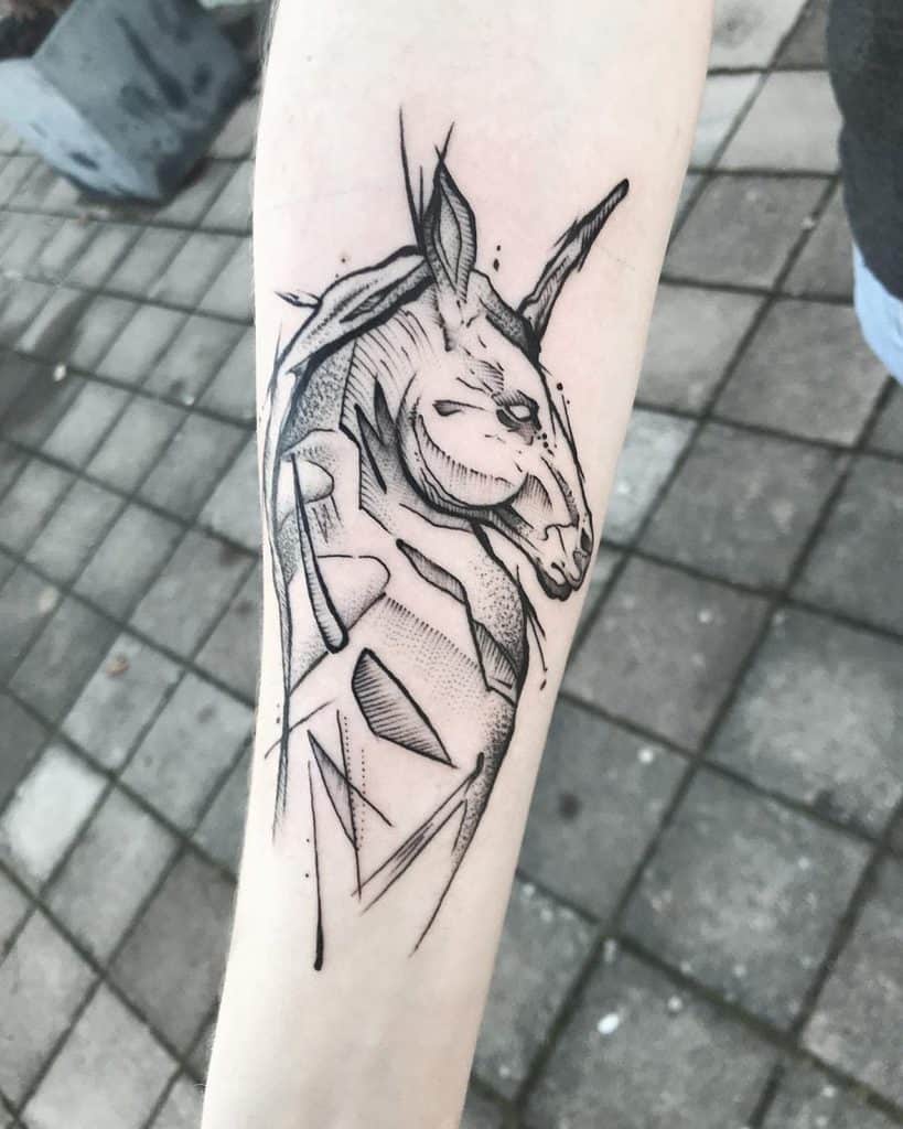 Abstract black ink tattoo of a unicorn with geometric and sketch-style elements, blending fantasy with a modern, edgy design.