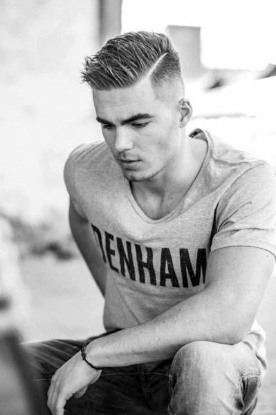 Sharp side part with a high fade and a neatly combed top