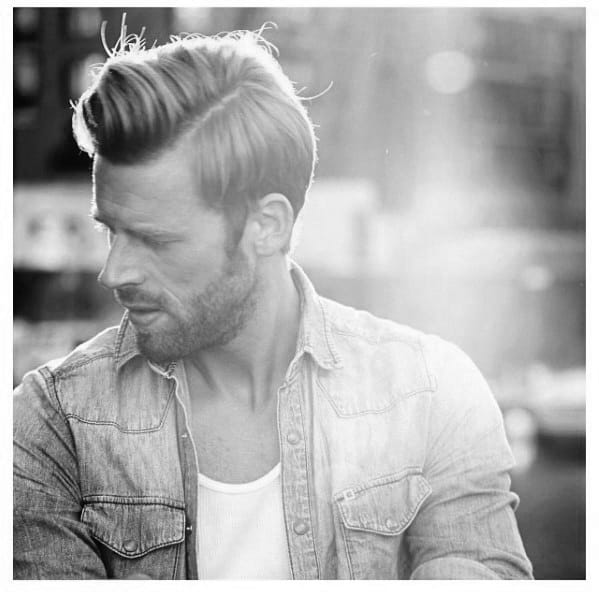 Voluminous side-swept quiff with a natural flow and a clean undercut