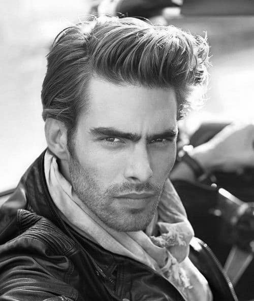 Voluminous, textured quiff with a natural side part and medium length