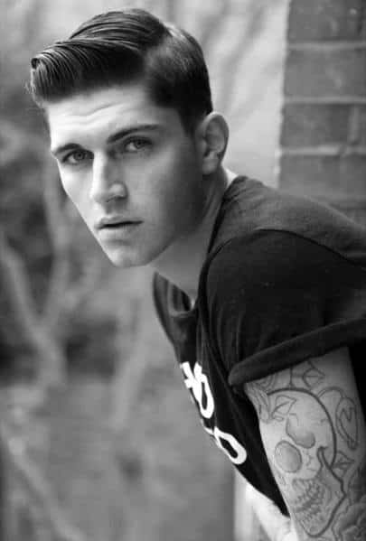 Classic side part with a sleek, polished finish and a low fade