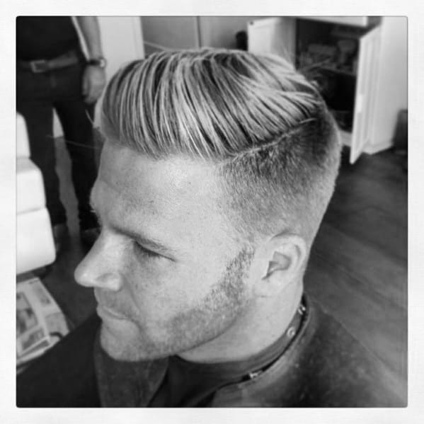 Sleek side part with a high fade and neatly combed top