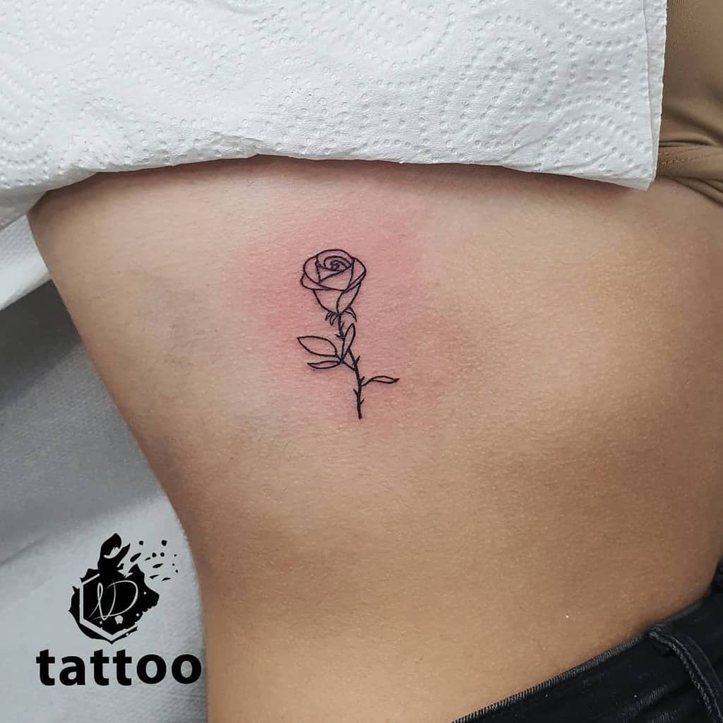 Simple rose tattoo on a woman's side