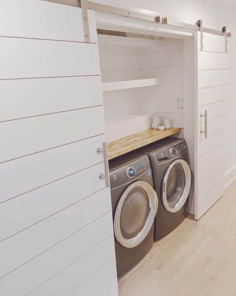 side by side laundry hidden behind shiplap doors