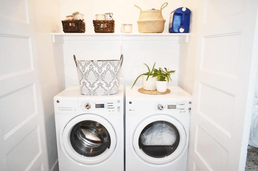 washer and dryer hidden by white bi-fold doors