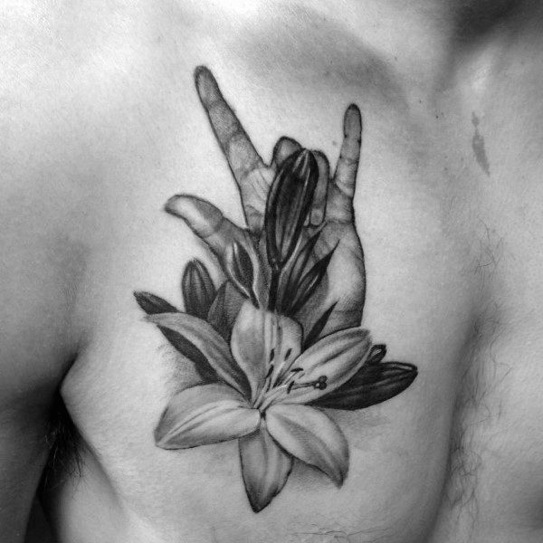 realistic black and grey tattoo of a hand making the "I love you" sign in American Sign Language, intertwined with detailed blooming lilies on the chest
