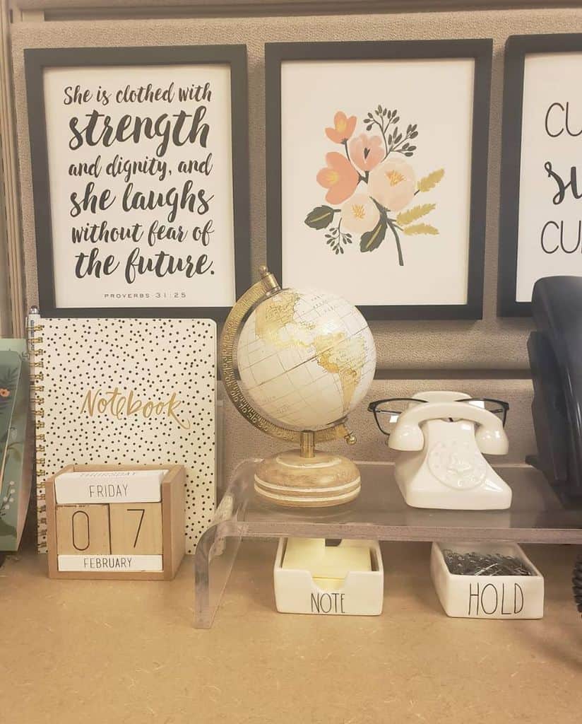 framed quotes and drawings office cubicle globe