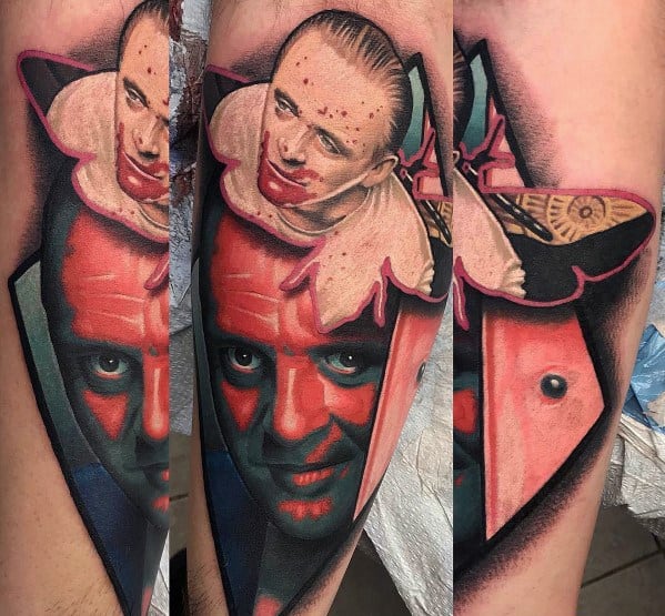 Realistic color tattoo of Hannibal Lecter from *The Silence of the Lambs*, featuring his intense gaze, a bloody scene, and the iconic death’s-head moth.