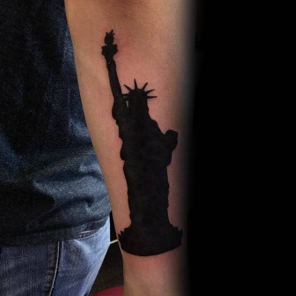 Silhouette Of Statue Of Liberty Tattoo On Mans Forearm