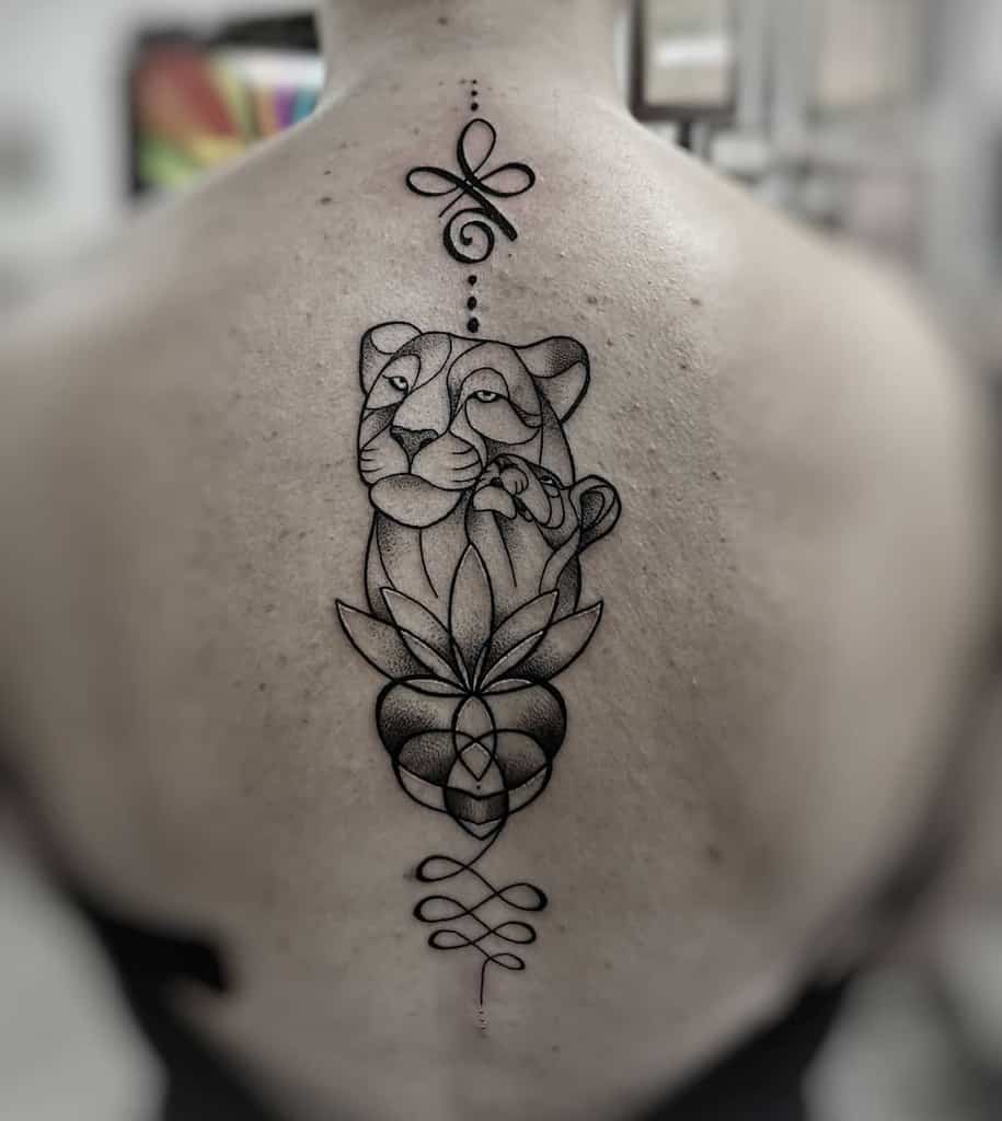 Geometric lioness and cub tattoo on the upper back, featuring fine linework, dot shading, and a lotus flower for a symbolic and elegant design.