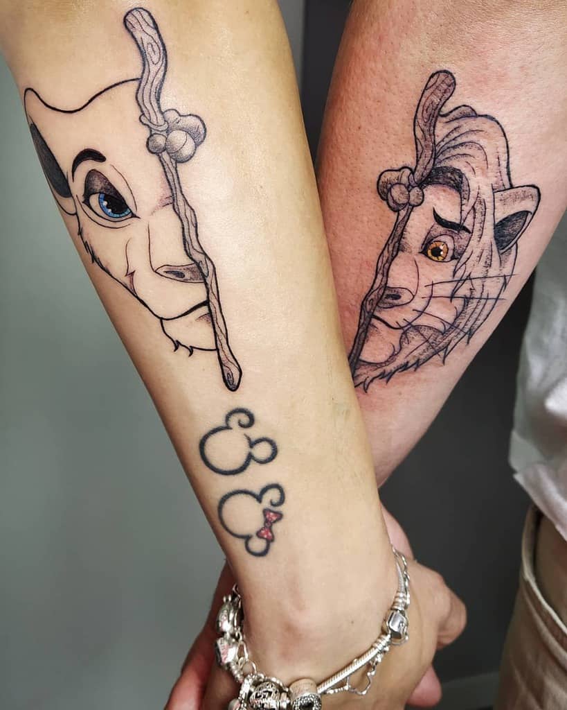 Matching tattoos of Simba and Nala, with a symbolic stick separating the two, representing their growth and connection