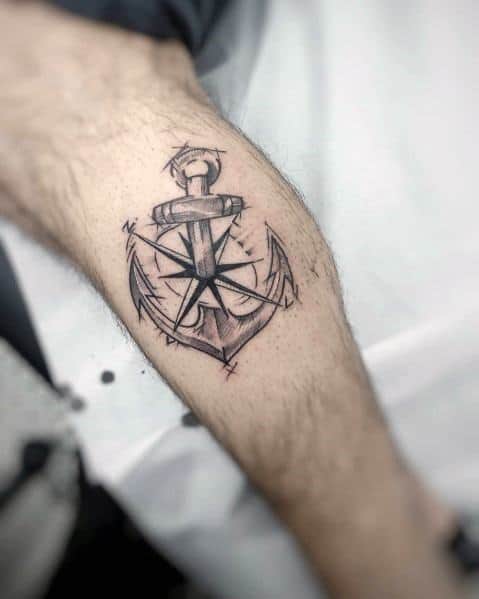 Sketch-style anchor and compass tattoo with fine black lines and rough shading, symbolizing guidance, stability, and a love for adventure.