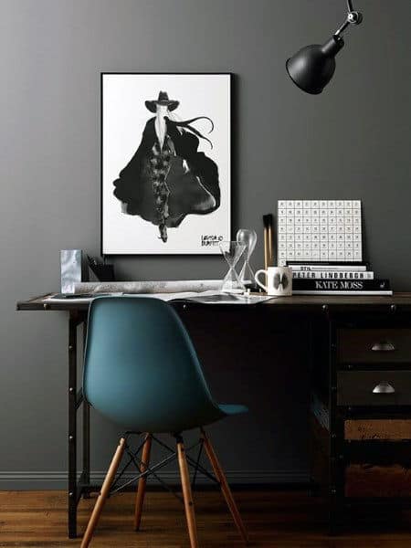 Stylish home office with dark decor, a chic poster, and modern furnishings