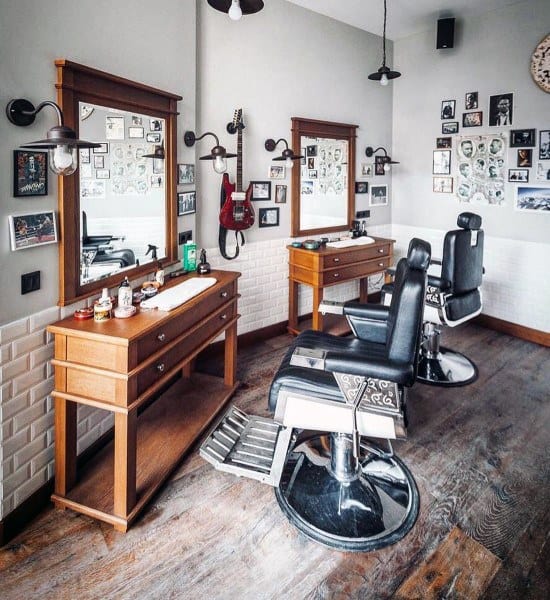 Barbershop with wooden mirrors, vintage chairs, and wall decor featuring guitars and photos.