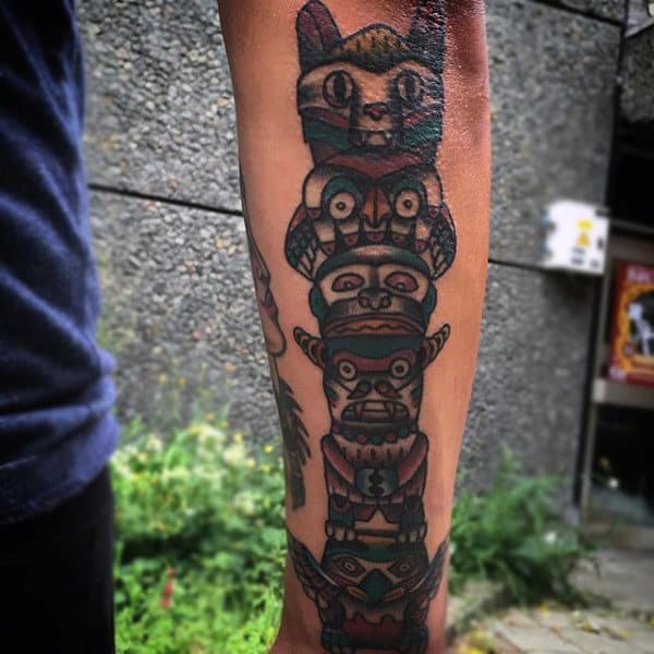 Simple Colorful Totem Pole Forearm Tattoo On Gentleman