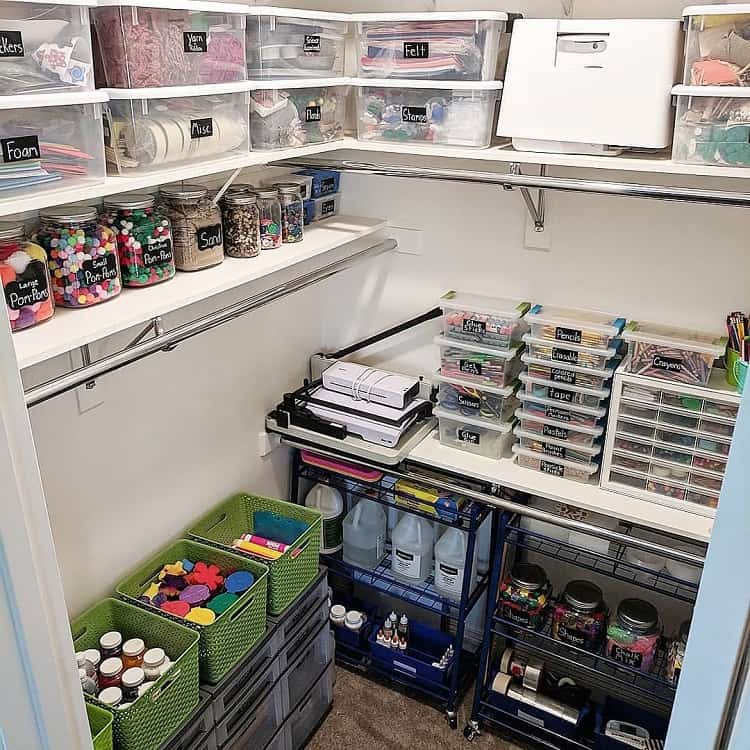 Organized craft closet with labeled containers and bins holding various art supplies and materials