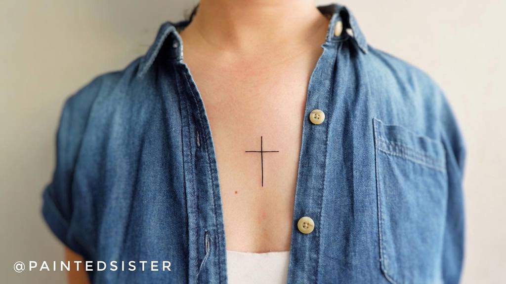 Small cross tattoo on woman's chest