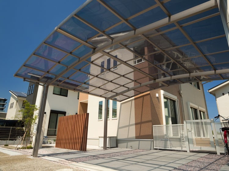 curved detached metal and glass carport