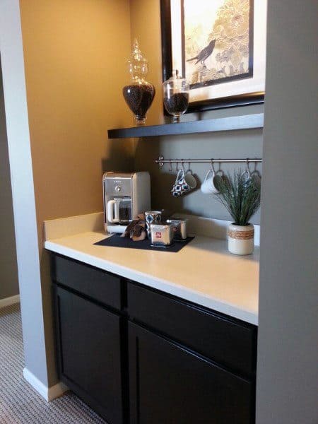 Simple coffee bar with dark cabinets, quartz countertop, coffee maker, and decorative accents.