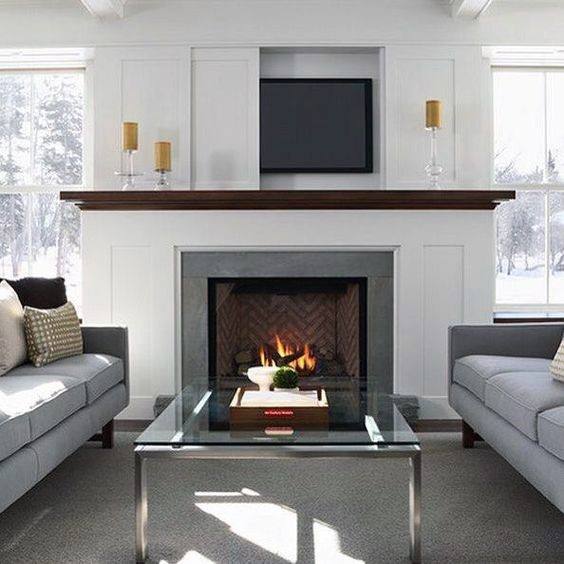 Bright living room with a modern fireplace, herringbone firebox, and a dark wood mantel.