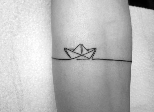 Minimalist black ink tattoo of a paper boat floating on a simple horizon line, symbolizing calm, journey, and simplicity.