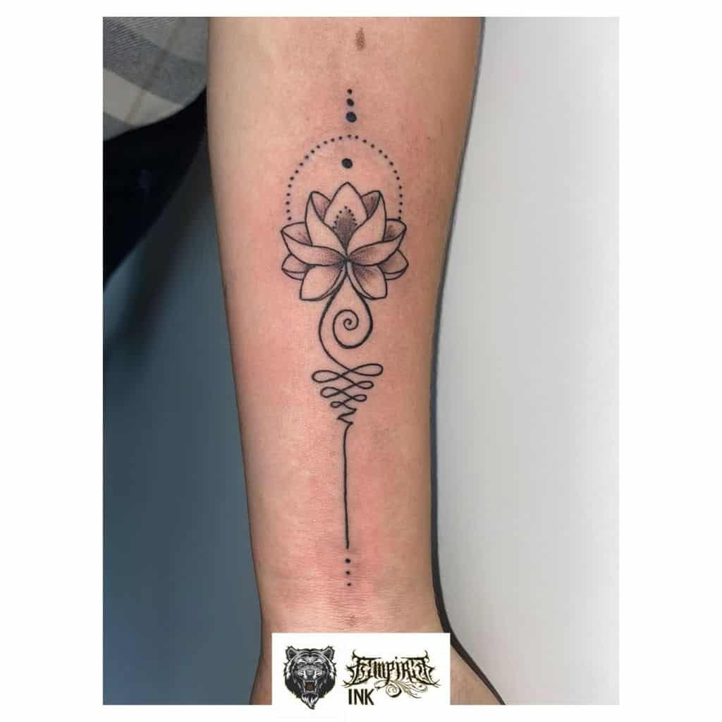 Simple black lotus tattoo with intricate lines and dots on a forearm