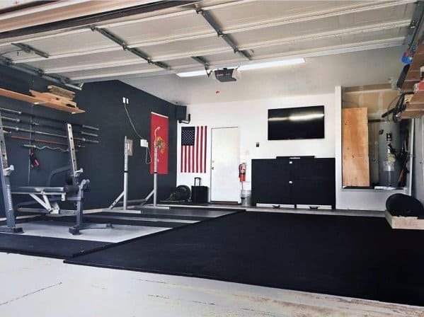 Simple garage gym with a bench press, barbell rack, and spacious workout area.