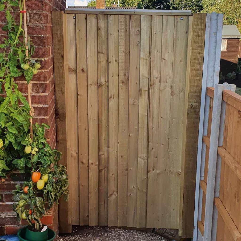 simple wood garden gate tomato plant