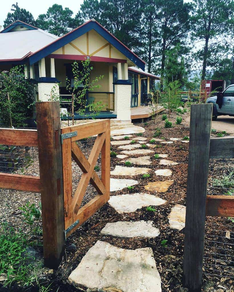 simple wood garden gate stone path