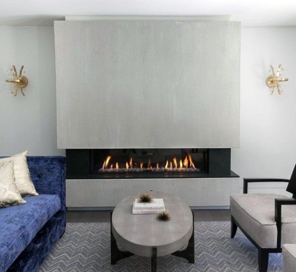 Elegant gas fireplace with a sleek concrete surround in a modern living room setting.