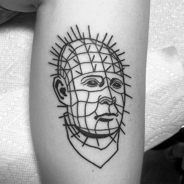 Minimalist *Hellraiser* tattoo of Pinhead, featuring bold black outlines, a simplified pin grid, and a clean, geometric design for a unique look.