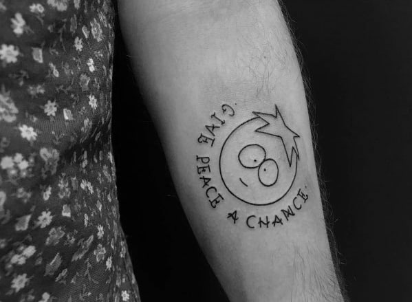 Minimalist black and white South Park tattoo of Butters with the phrase 'Give Peace a Chance' curved around his face in simple line art.