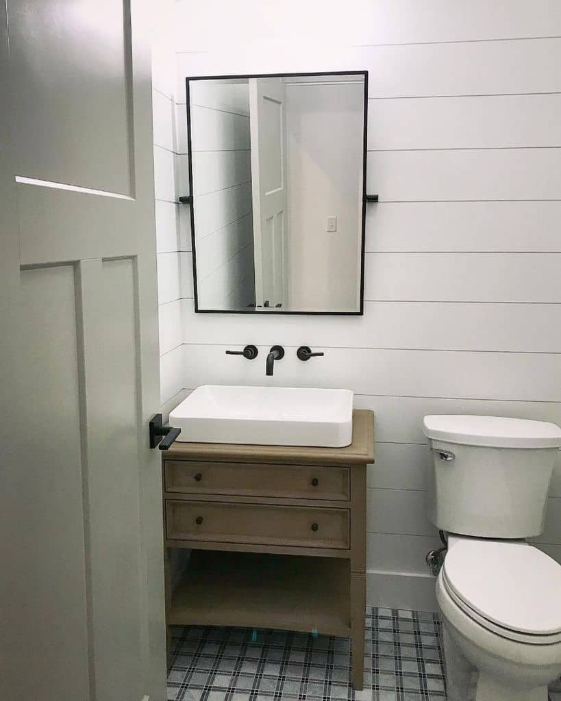 white shiplap wall powder room