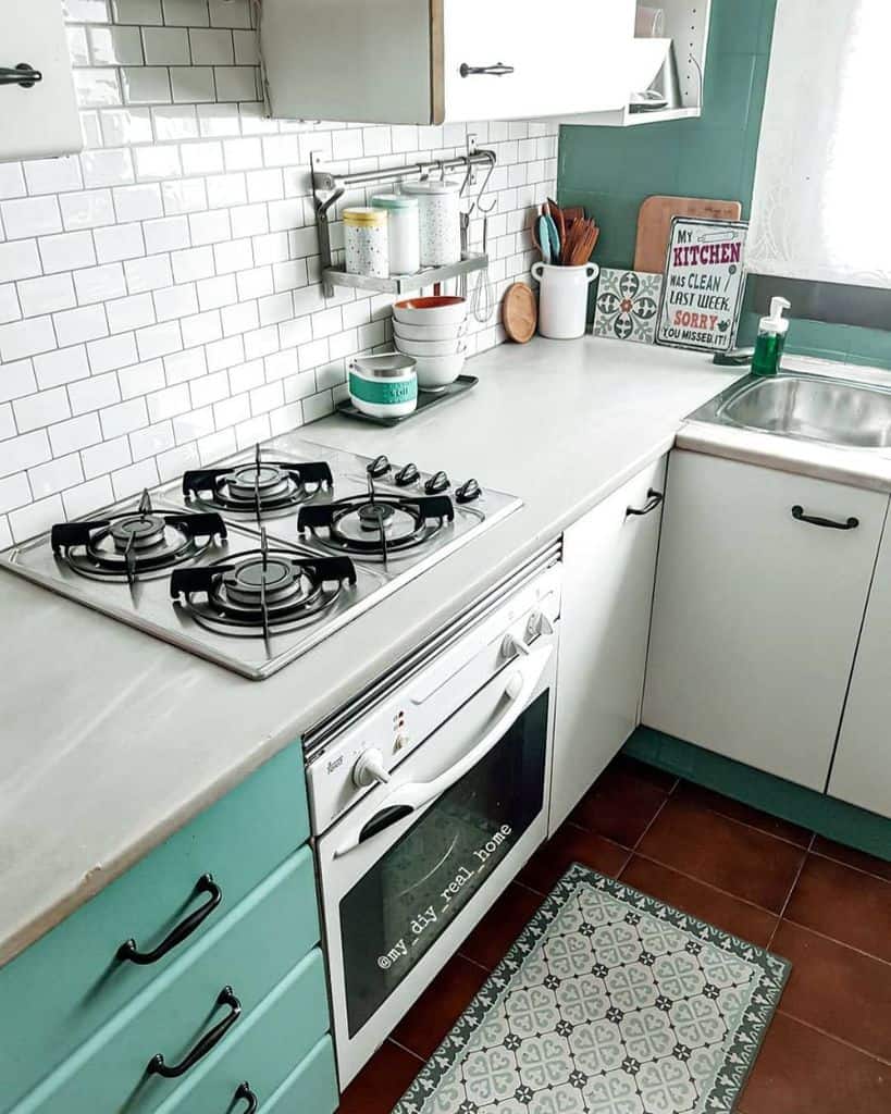 simple corner kitchenette white cabinets and tile backsplash