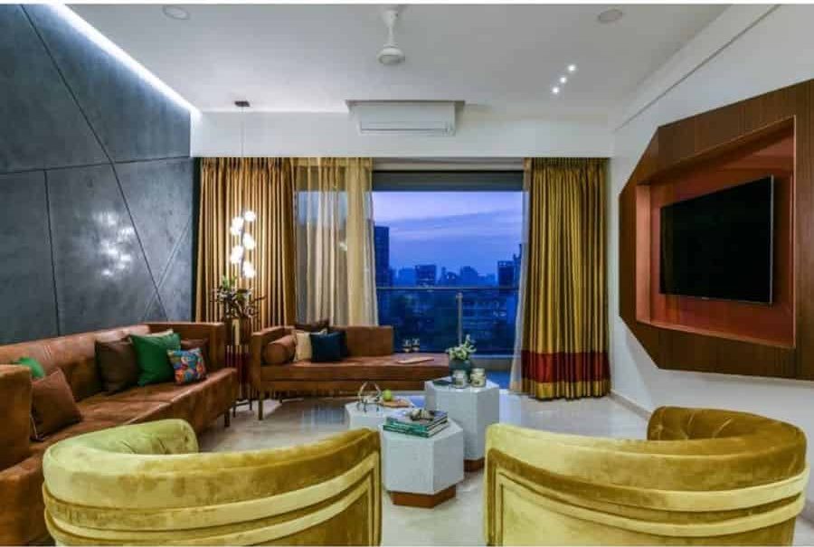 eclectic living room tan sofas yellow accent chairs gray geometric shape feature wall