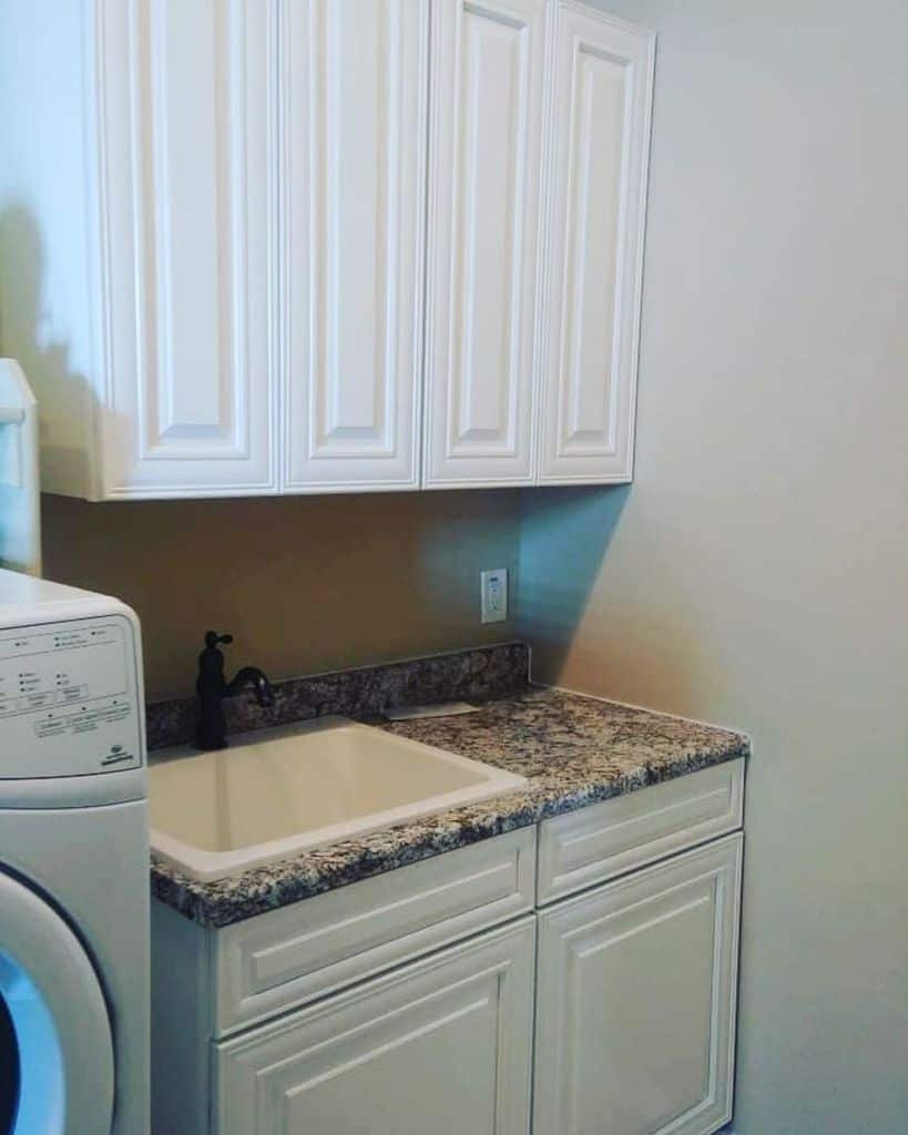 simple white cabinet laundry sink