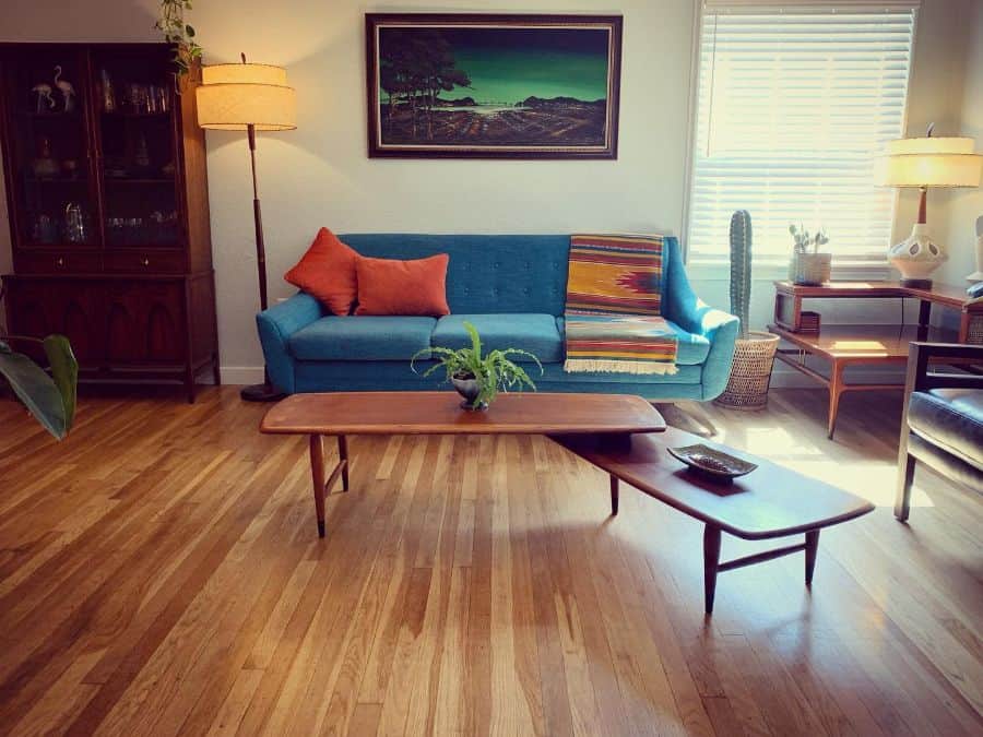 retro living room with blue sofa and wood coffee tables 