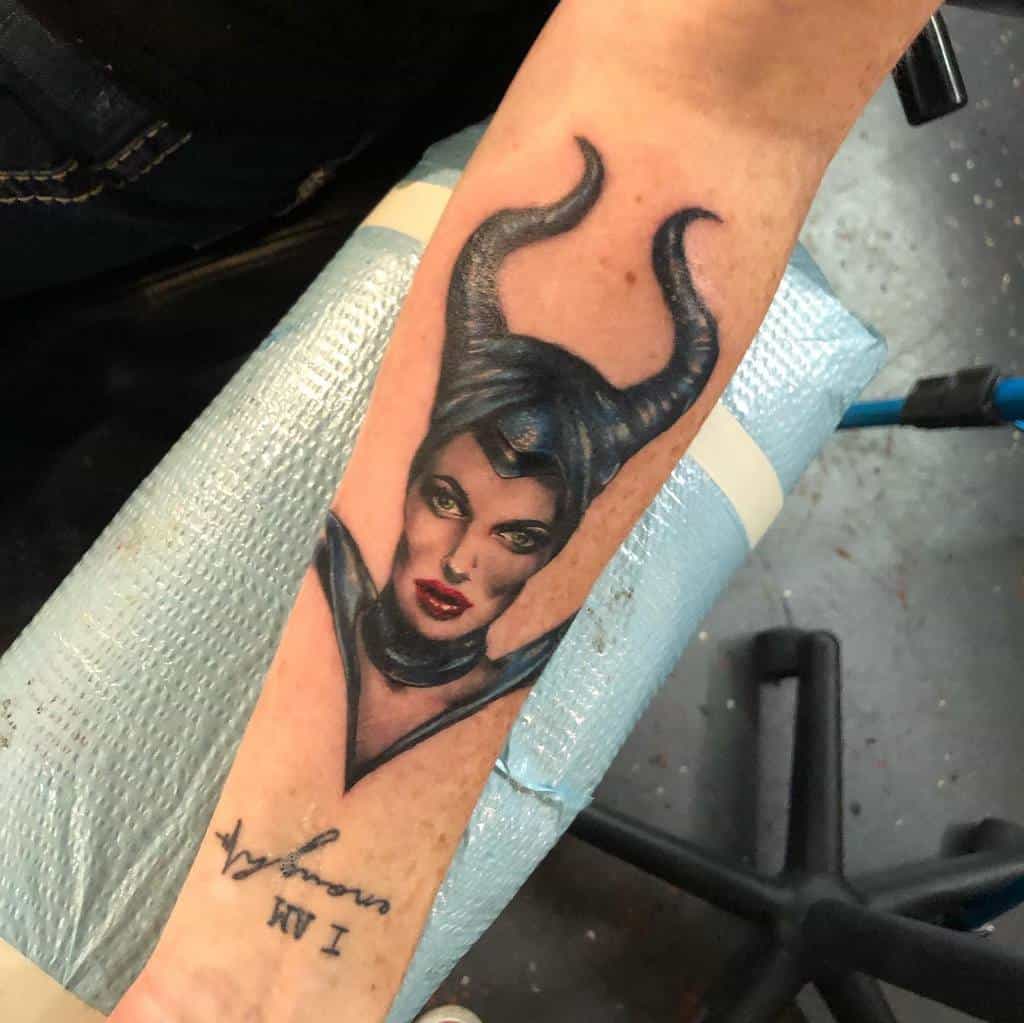Elegant Maleficent tattoo with bold shading and striking red lips, bringing her fierce and captivating presence to life on the skin