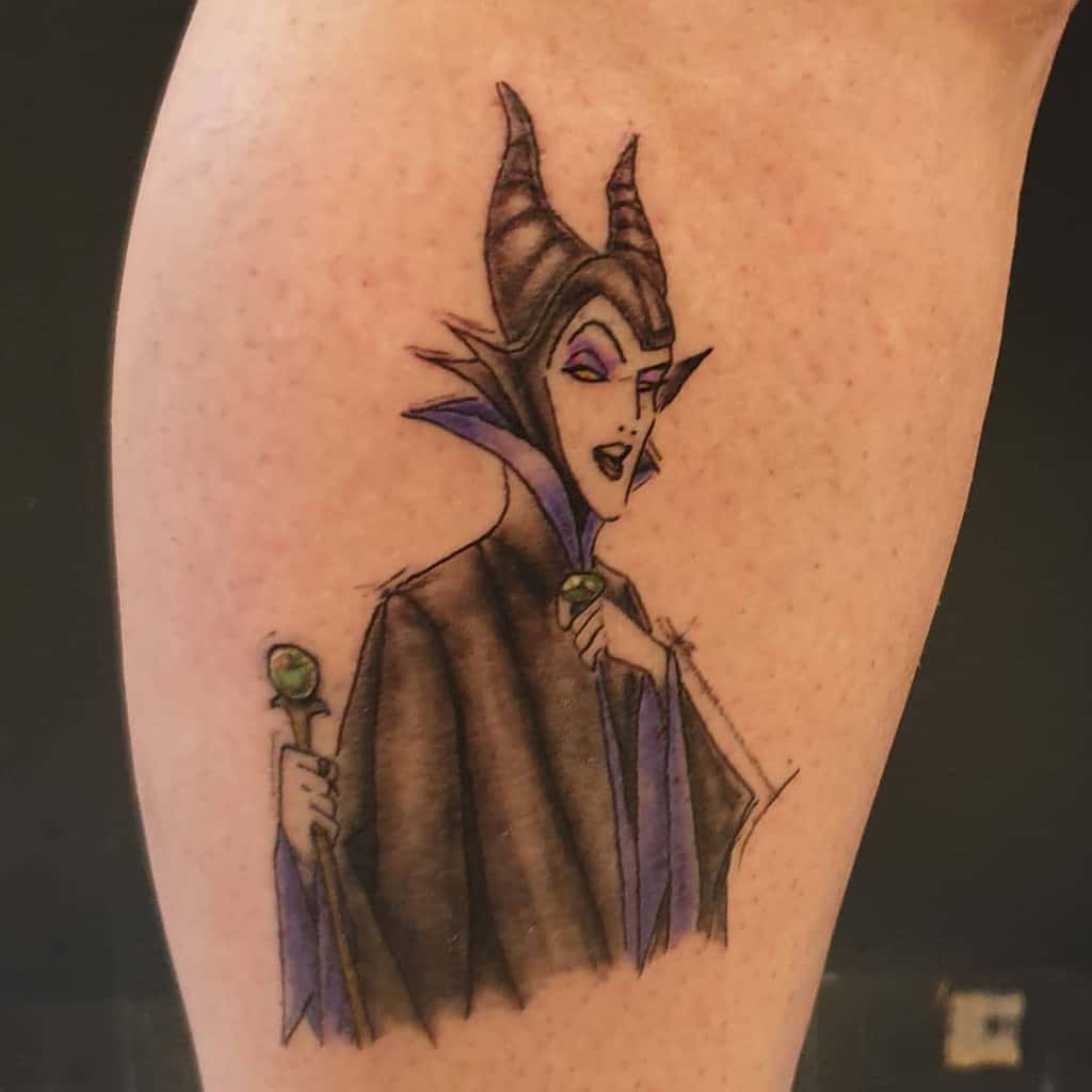Classic animated Maleficent tattoo showcasing her signature pose with a staff and iconic purple accents