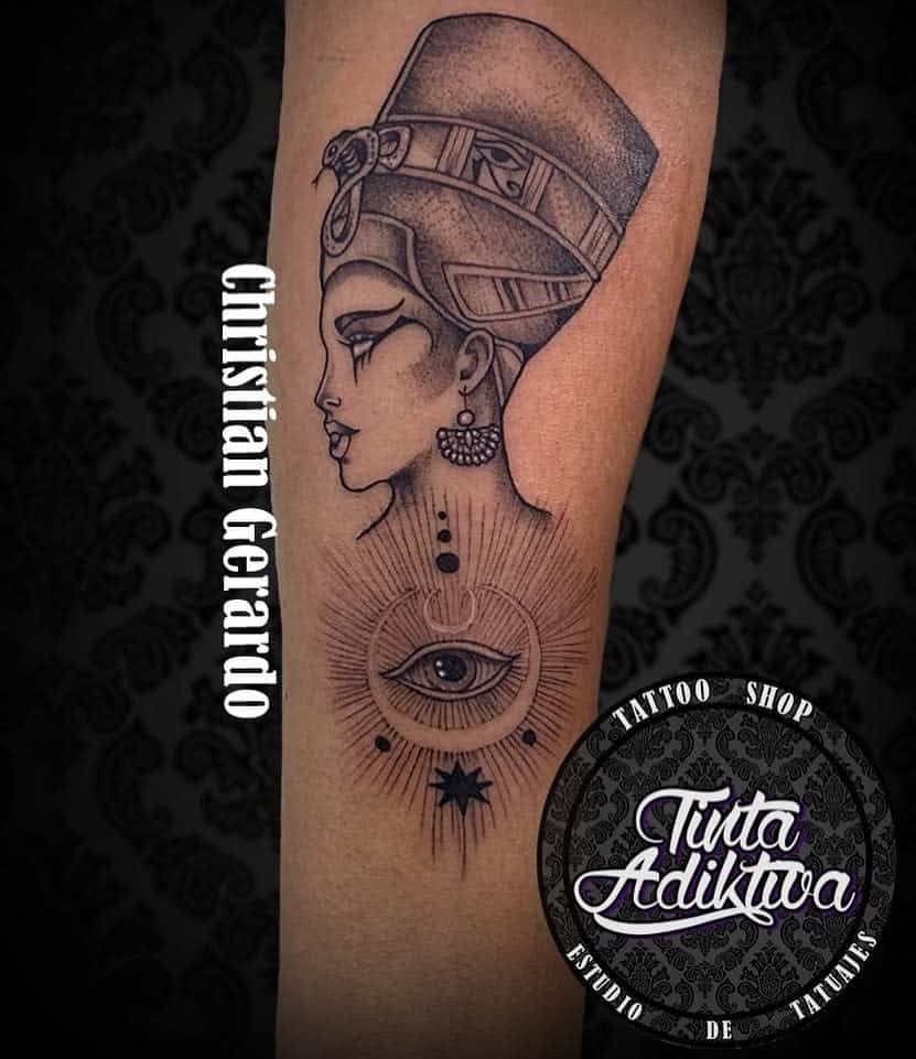 Tattoo of an ancient Egyptian queen with an eye and sun design below