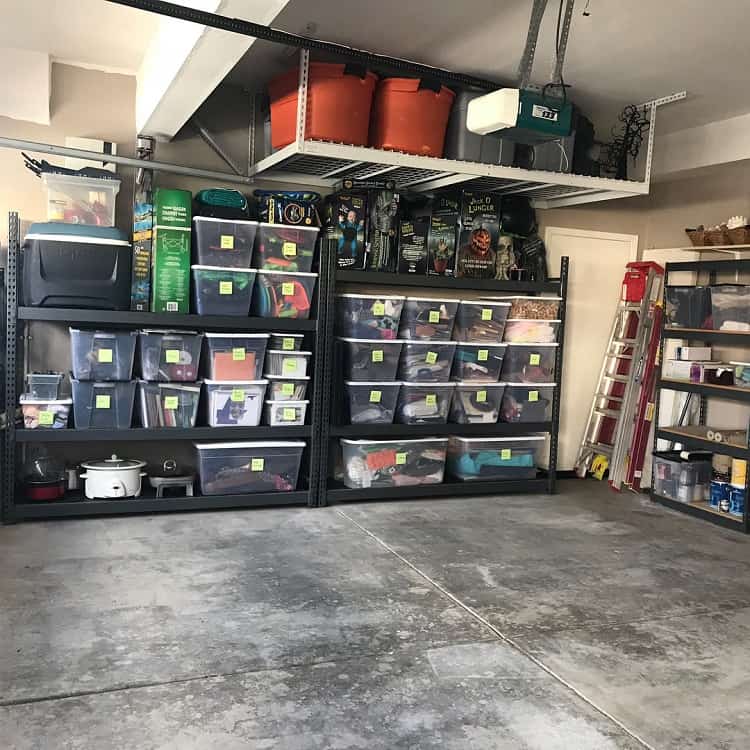 Basement with labeled storage bins on shelves and overhead storage holding seasonal items and gear.