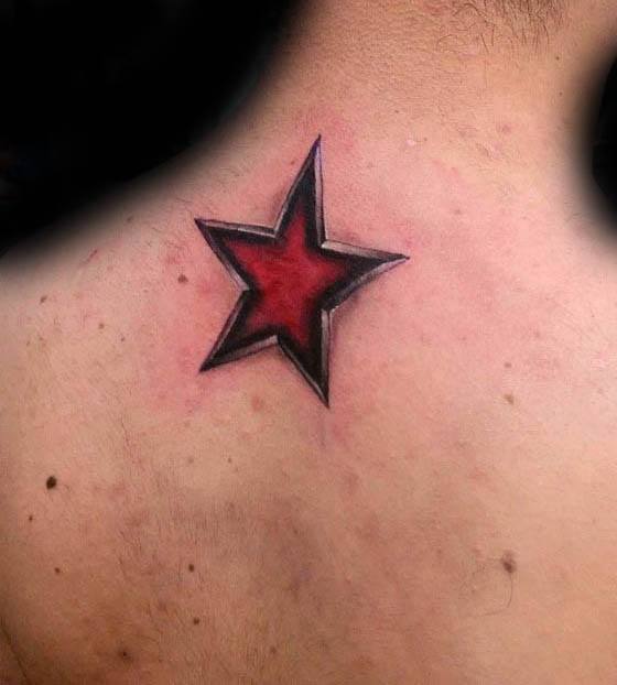 3D red star tattoo on upper back with bold shading and shadowed edges, giving it a sharp, carved-in appearance.