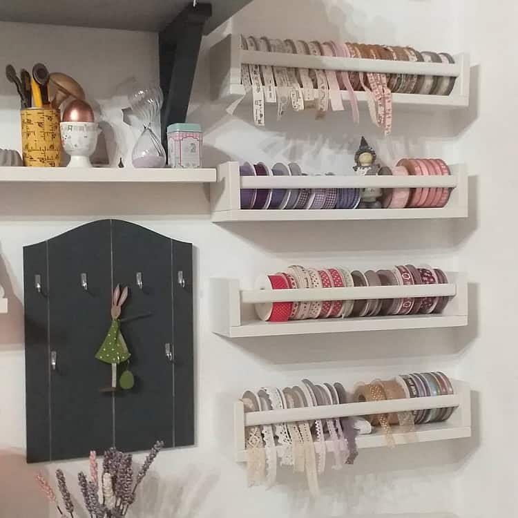 Craft room with shelves holding colorful ribbons and jars