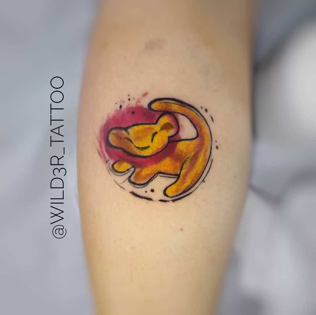 Tattoo of a stylized Simba as a lion cub in an orange and red color scheme