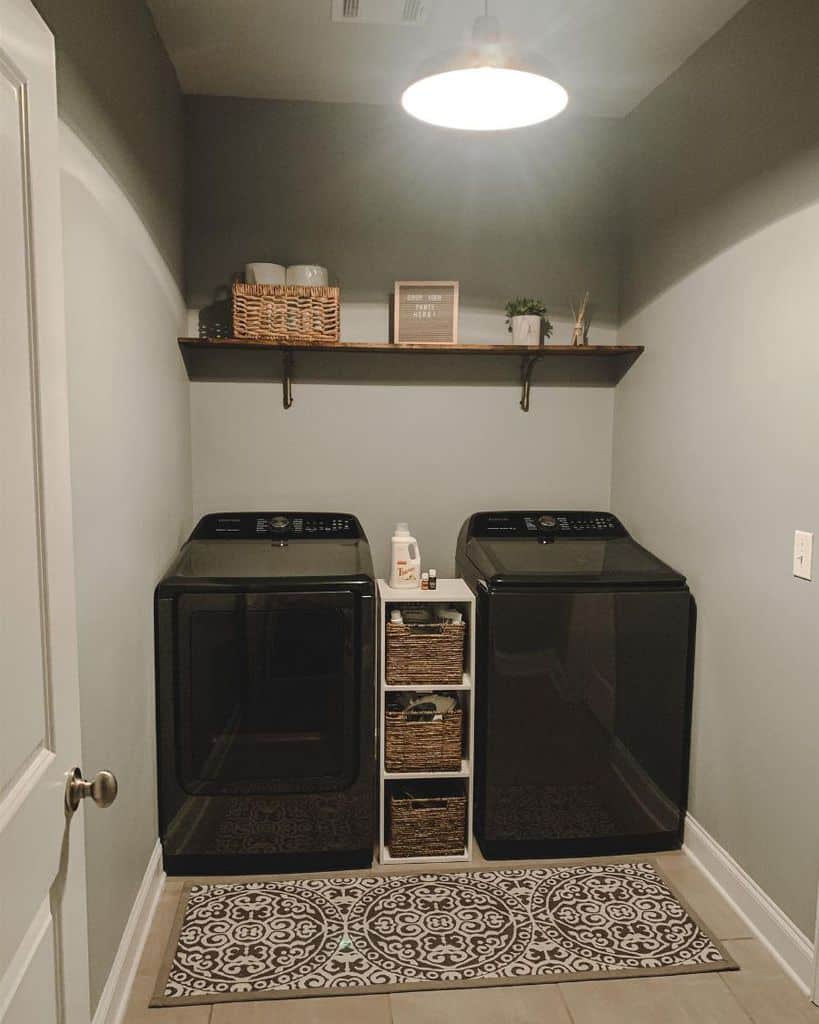minimalist laundry room with black washer and dryer