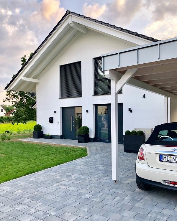 simple white wooden carport gray paver driveway