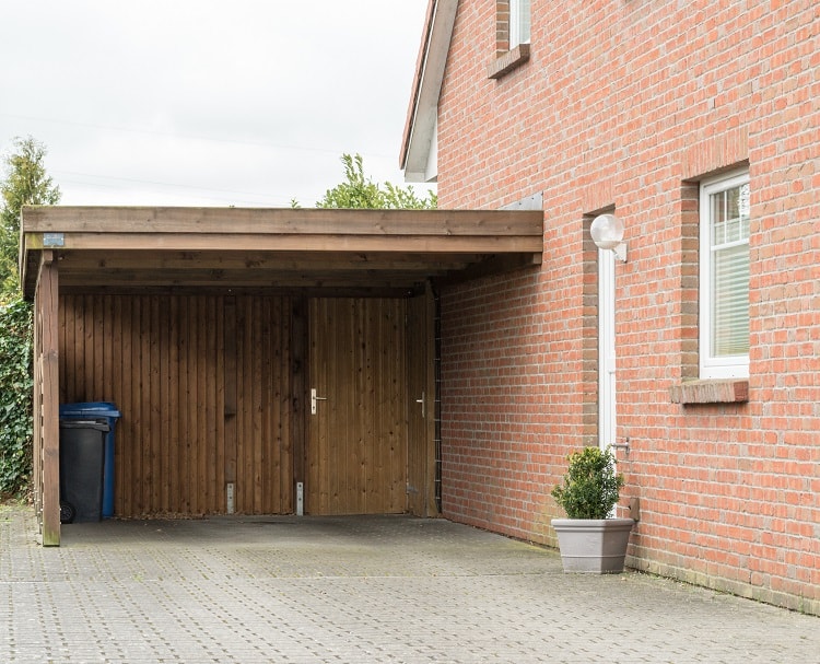 small wooden carport brick house